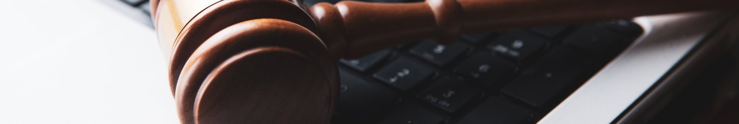 gavel resting on a laptop keyboard