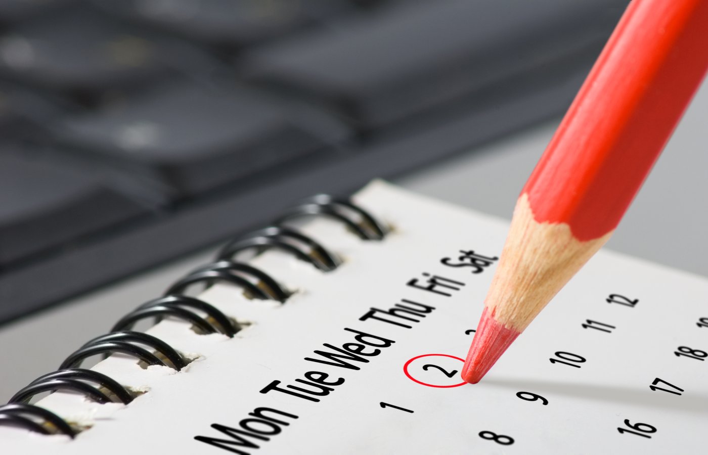 calendar with red pencil making red circle around date