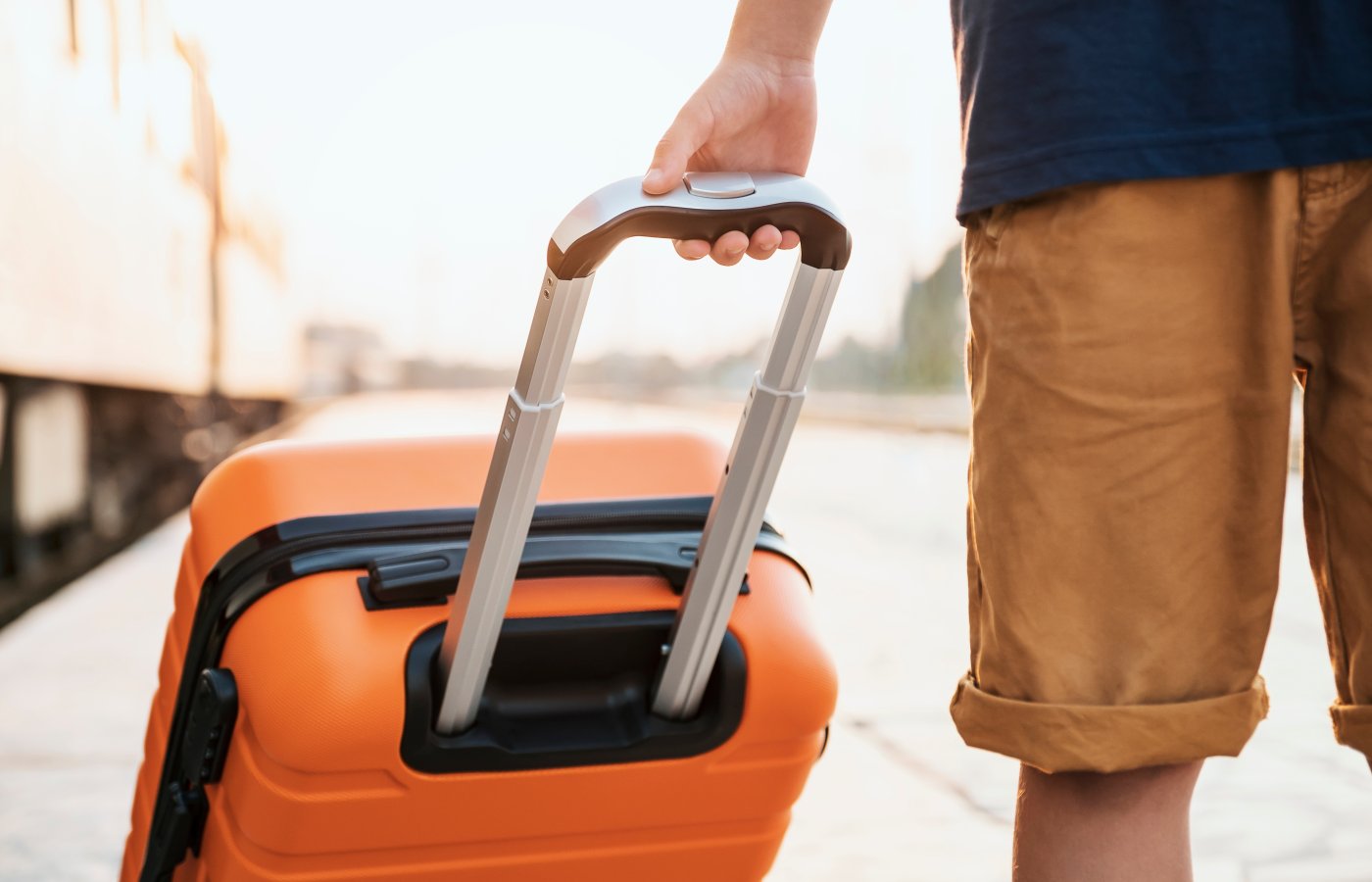 Person holding suitcase