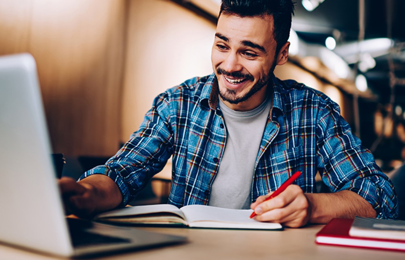 man looking at laptop, smiling