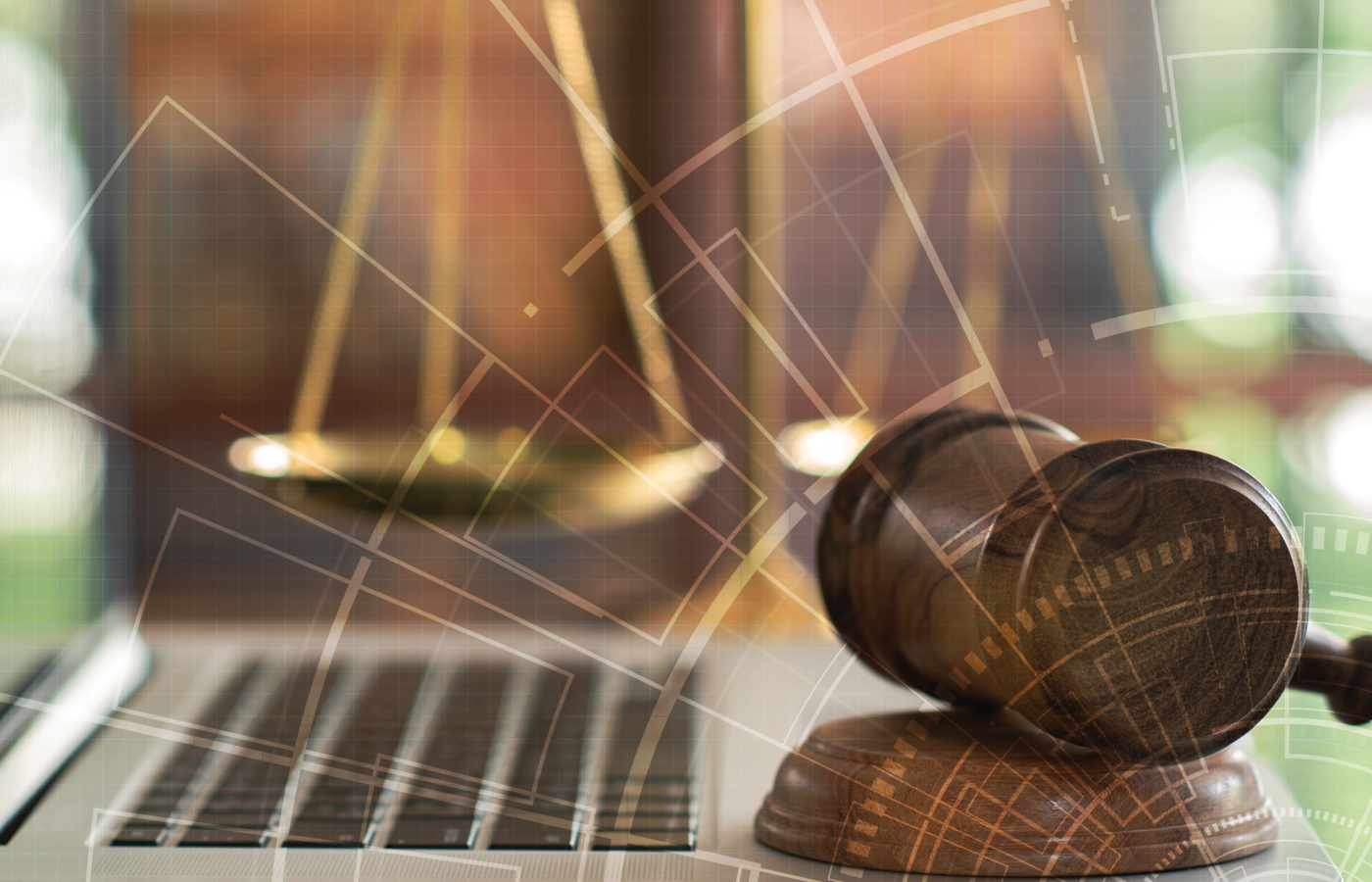 gavel on top of computer with a blueprint overlay