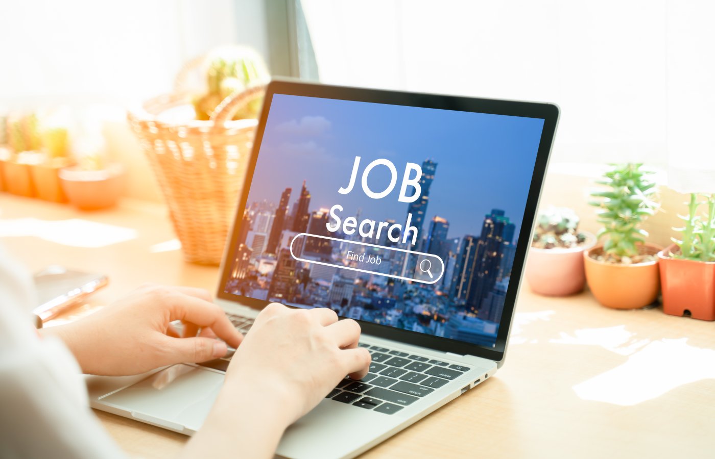 person on laptop with job search screen showing