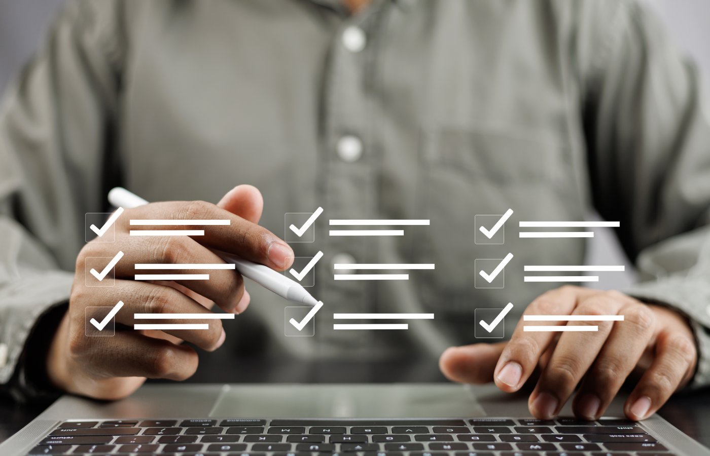 close up of person's hands at a computer keyboard with icons of checkmarks and lists overlaying the image. Conveys test questions in a digital platform