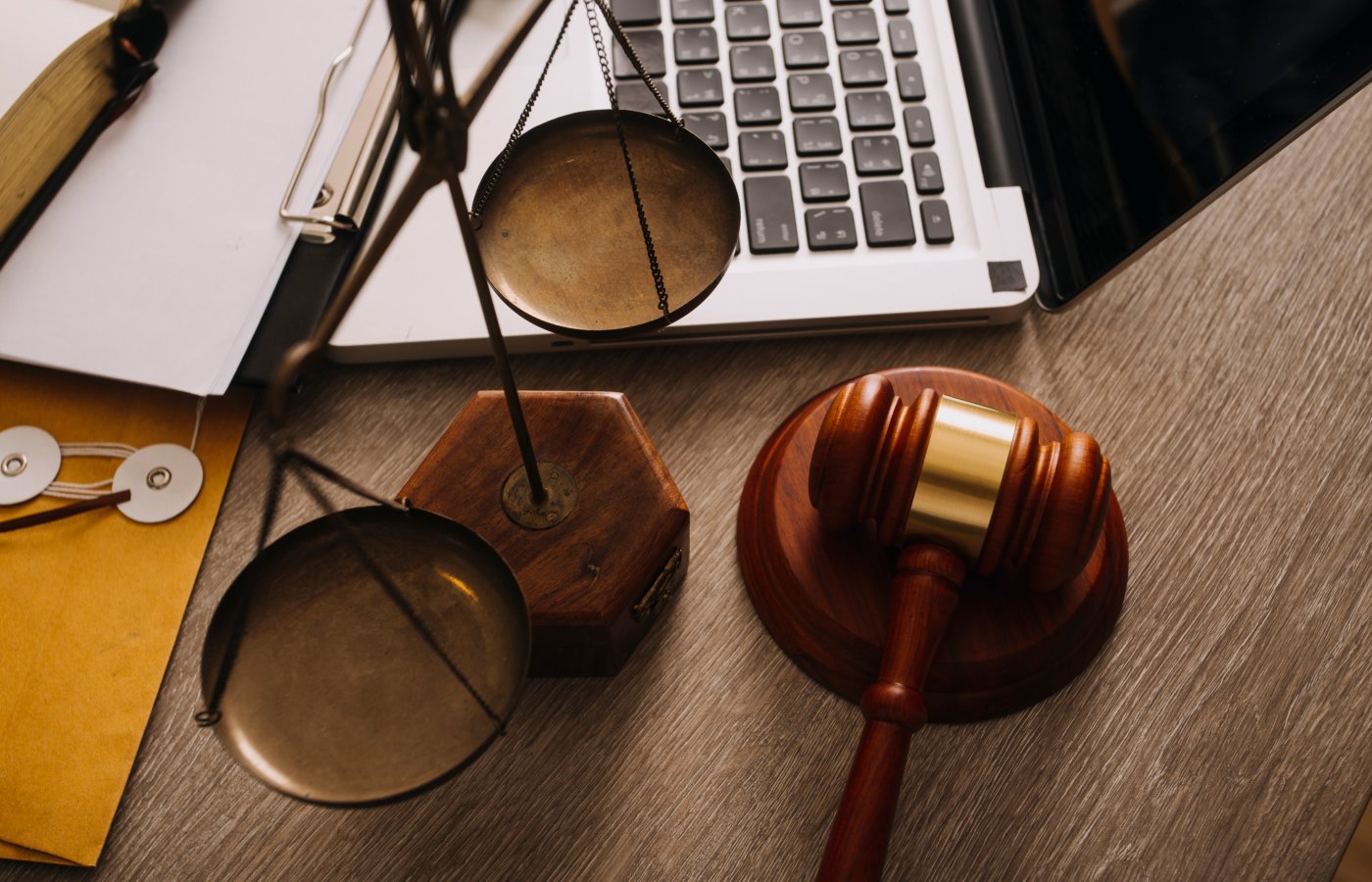 overhead view of a laptop, gavel, scale, and papers