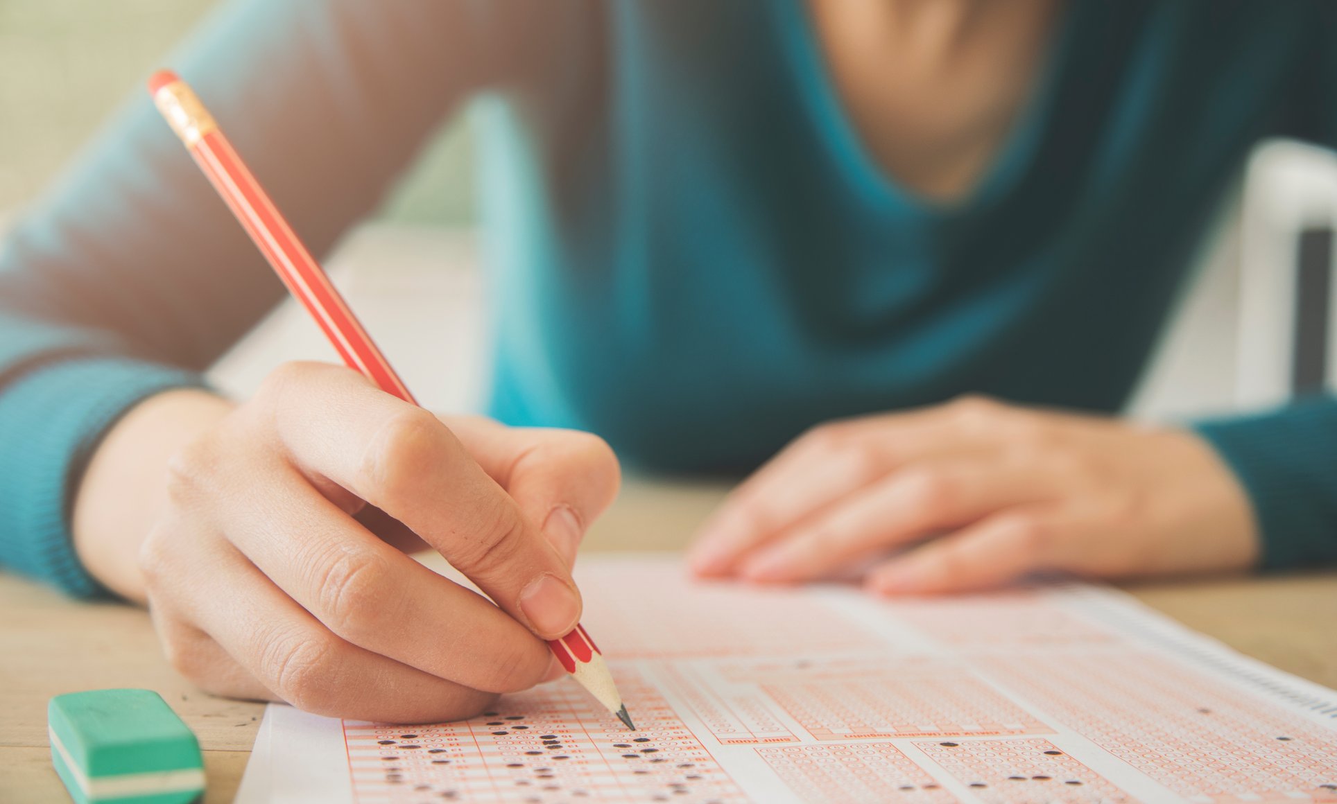 person taking test with pencil