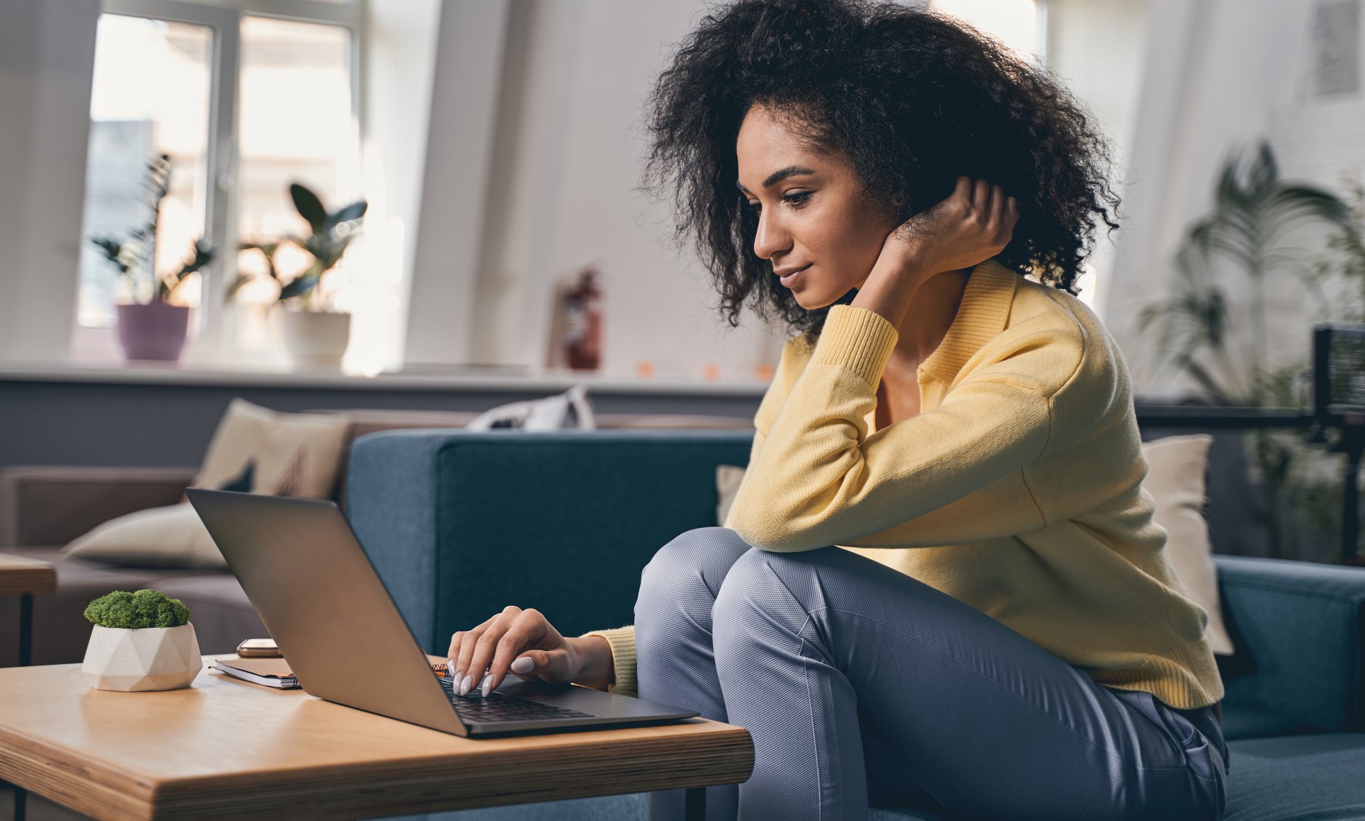 Woman sitting and looking at laptop