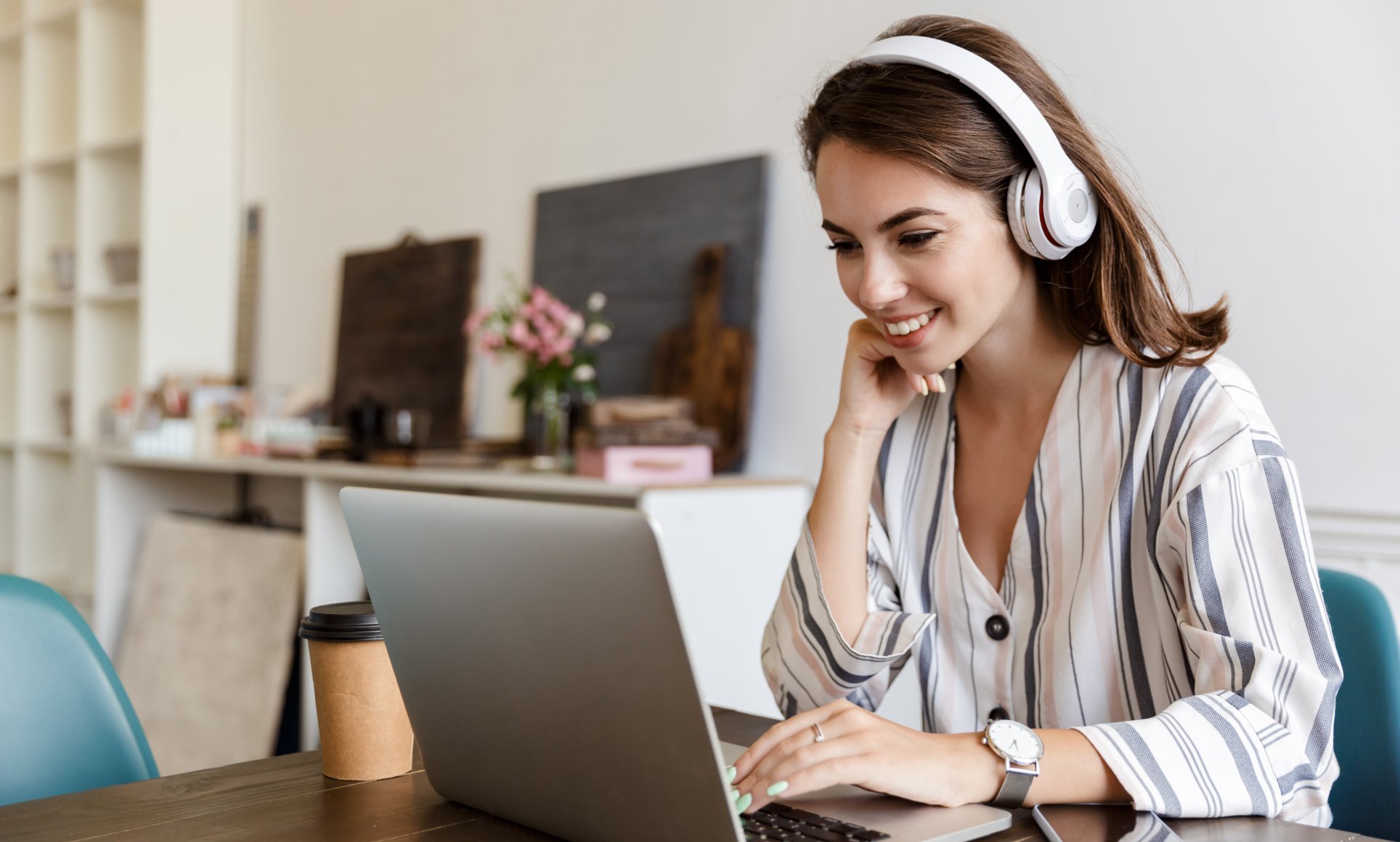 woman on computer wearing headphones
