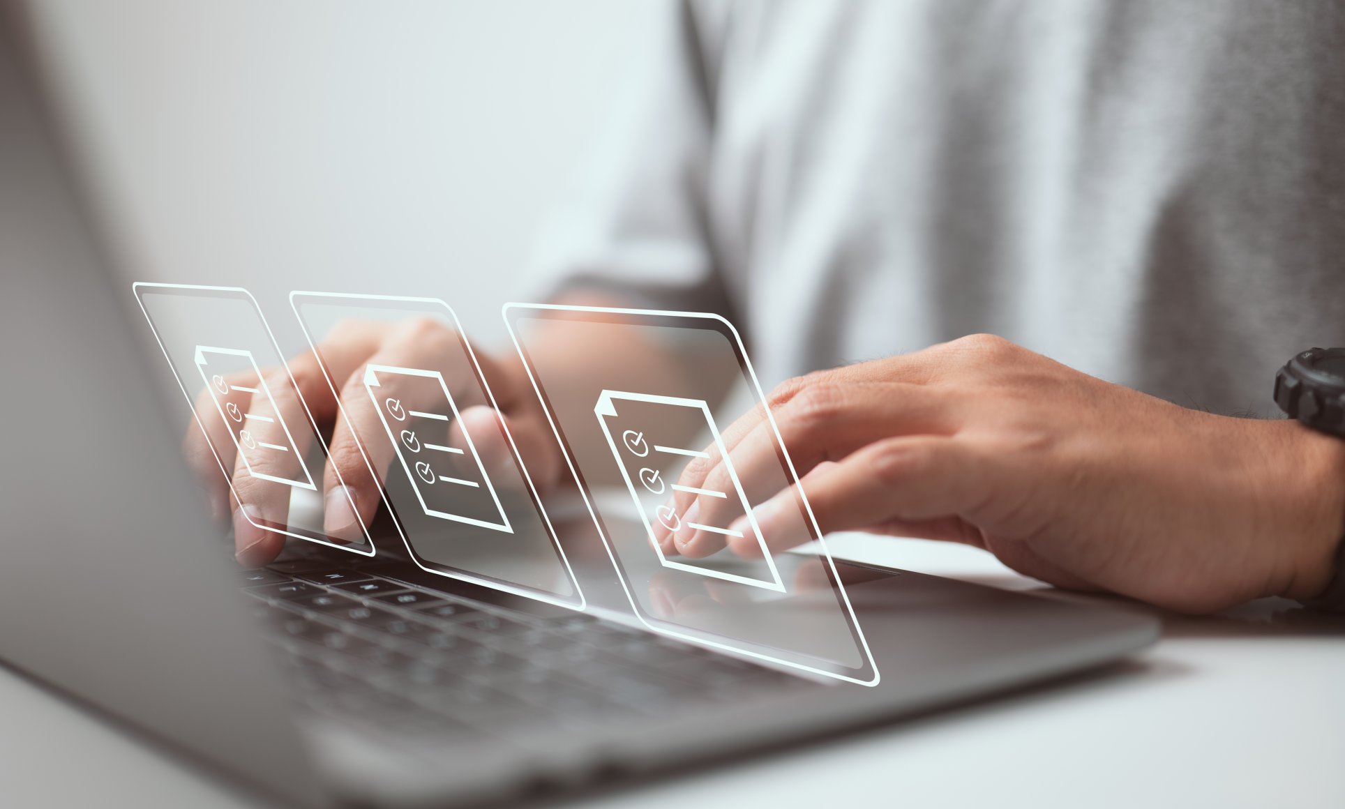 Hands typing on computer with hologram documents on top