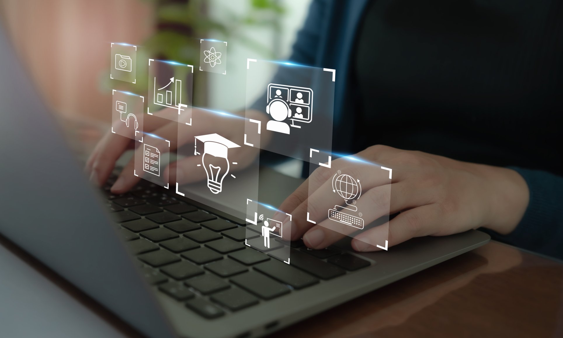 hands on keyboard with learning icons floating above
