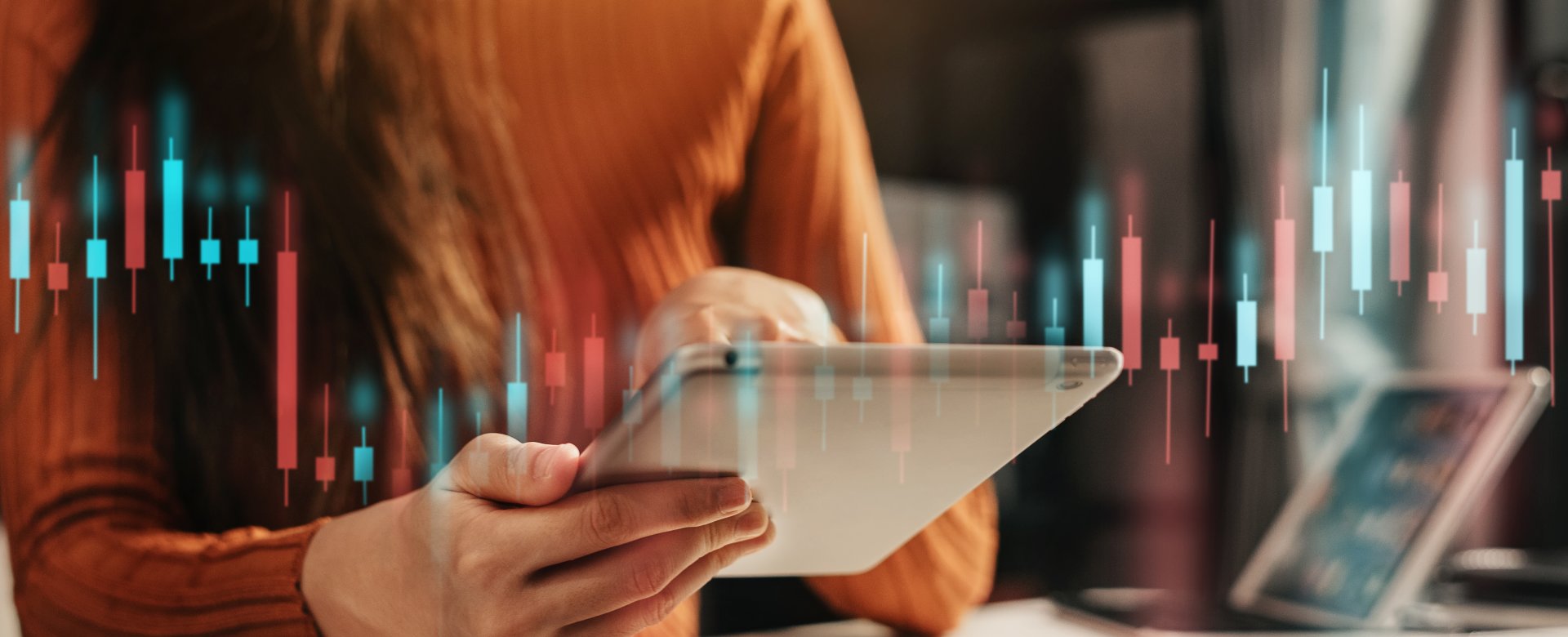 Woman looking at ipad with bar graphs above