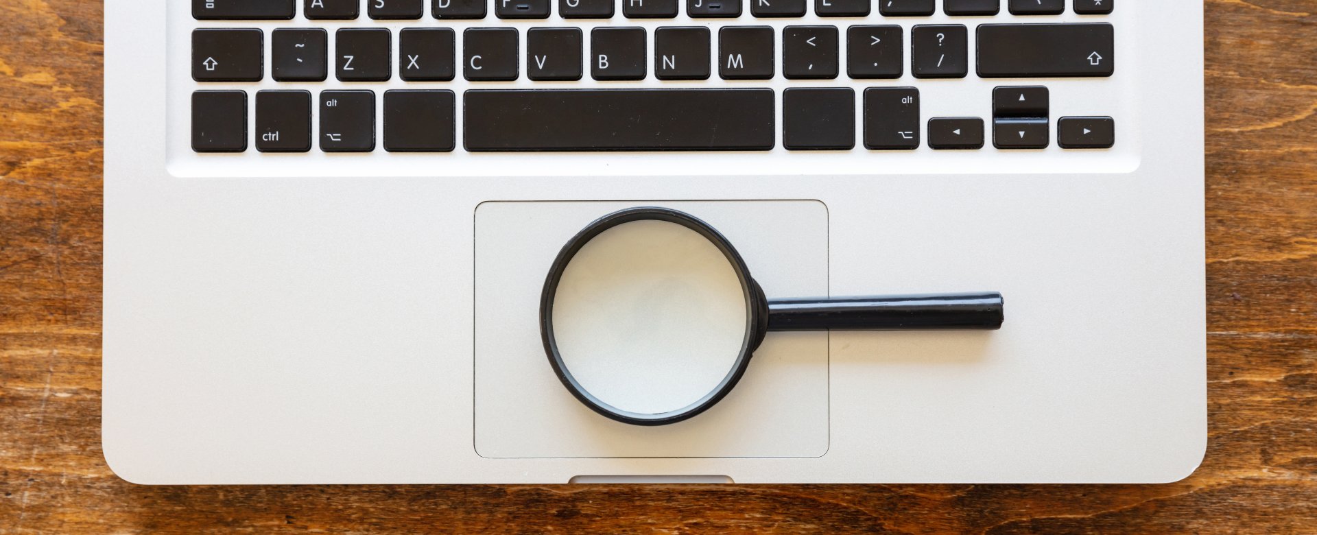 computer keyboard with magnifying glass on top