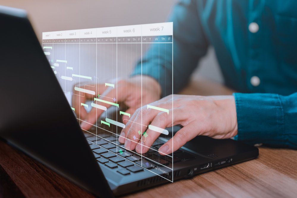 hands on computer keyboard calendar above