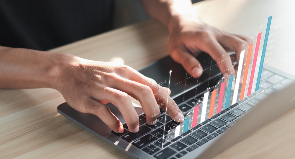 person's hands on keyboard with bar graph