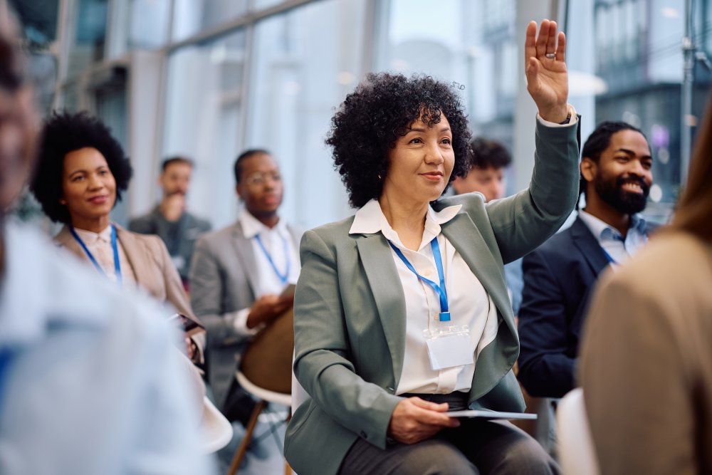 woman raising her hand at a press conference or meeting