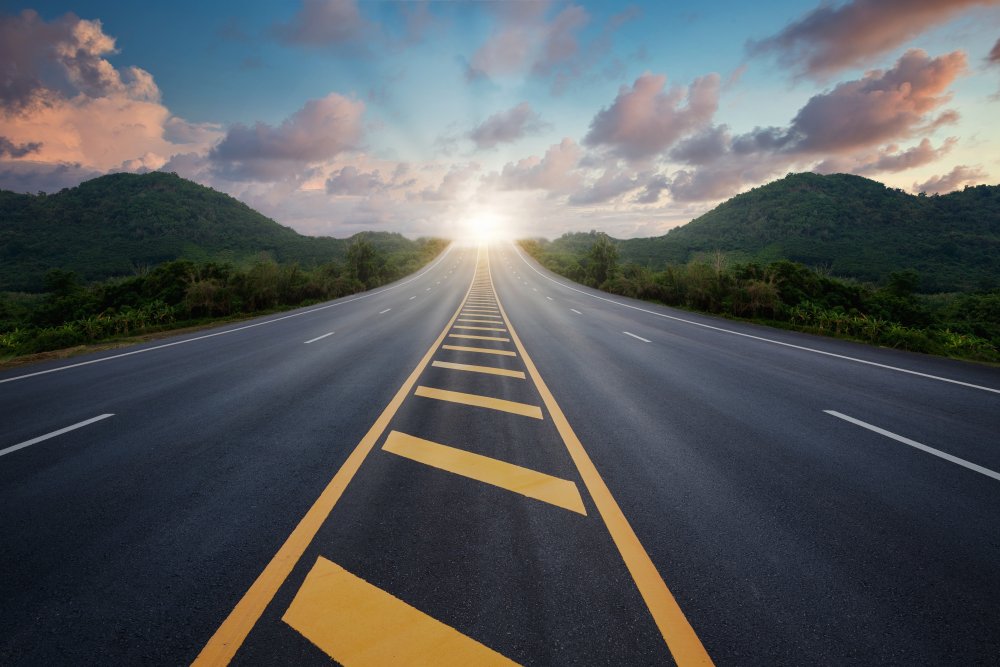 View of a road with sunrise in the distance